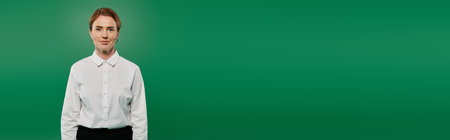 A confident woman dressed in formal attire stands against a bold green backdrop, prepared for call...