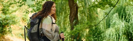 A confident woman embraces the outdoors, surrounded by vibrant greenery in a peaceful forest.