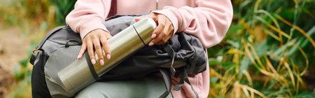A young woman embraces adventure, exploring a colorful forest during a beautiful autumn day.の写真素材