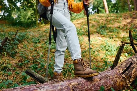 A young African American woman explores a forest trail, embracing the beauty of autumn foliage on her hike.の写真素材