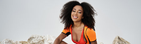 A beautiful young woman smiles radiantly while dressed in striking, modern apparel.の写真素材