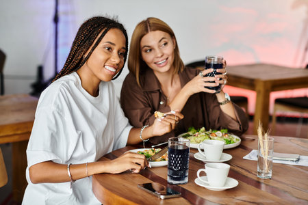 A joyful couple shares a delightful meal at a cafe, filled with smiles and affectionate moments.