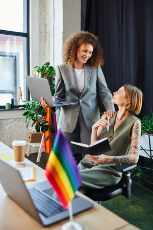 Two coworkers engage in a lively discussion filled with creativity and collaboration.の写真素材