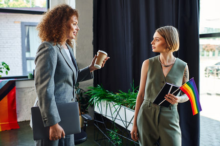 Two coworkers engage in an inspiring conversation while promoting LGBTQ pride and unity.の写真素材