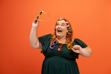 A cheerful plus size woman playfully poses with colorful accessories against a bright backdrop.