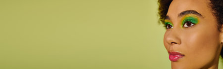 With striking makeup, a young woman showcases her emotions while gazing thoughtfully ahead.の写真素材