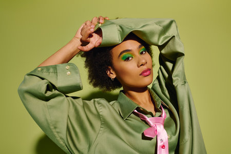 A young woman expresses deep emotion while showing a creative and colorful style in her outfit.の写真素材