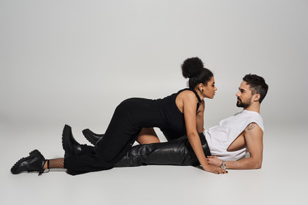 A couple engages in a tender moment of closeness, expressing love and attraction dramatically.