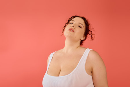 A radiant plus size woman stands gracefully, exuding confidence and charm in a stylish outfit.