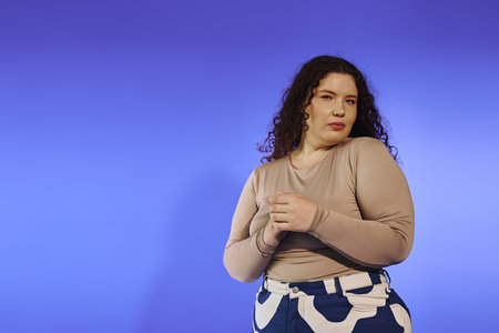 A beautiful plus size woman stands elegantly, radiating confidence with a captivating pose.