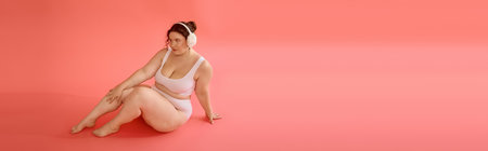 A plus size woman effortlessly showcases confidence and style in a chic, pastel environment.の写真素材