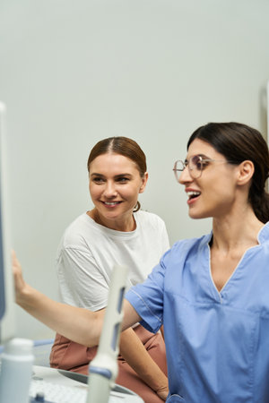 A gynecologist works with a female patient during a health checkup in a modern clinic.の写真素材