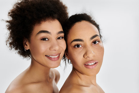 Two women showcase their natural beauty, beaming brightly with joy and confidence.の写真素材