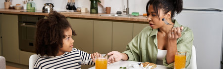 Mother and daughter share a joyful breakfast experience, enjoying each others company.