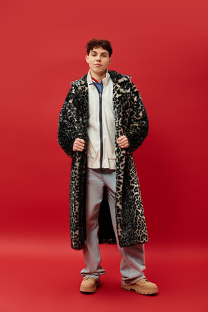 Handsome man stands confidently in a chic outfit, embodying modern style and elegance.
