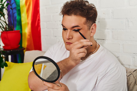 An expressive queer person enhances their look with makeup in a vibrant and welcoming room.の写真素材