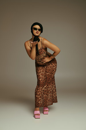A fashionable young woman strikes a fun pose, showcasing her trendy leopard print outfit.