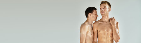 A young gay couple shares a tender moment, radiating love and closeness in a tranquil setting.の写真素材