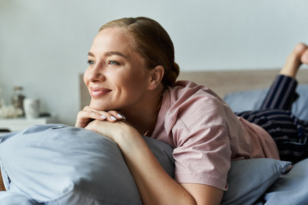 A young plus size woman enjoys a peaceful afternoon, lost in thought while lounging at home.の写真素材
