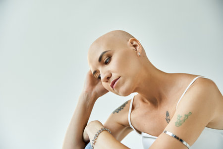 A young bald woman exudes grace and confidence, showcasing her unique beauty.