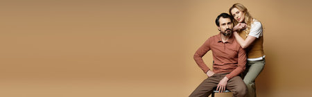 A couple sits together casually, showcasing their connection and comfort in a serene setting.の写真素材