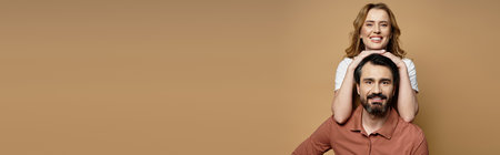A middle aged man and woman share a joyful interaction in a cozy environment.