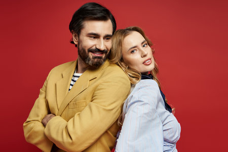 A cheerful middle aged couple shows off their lively personalities while posing back to back.の写真素材