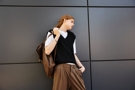 A young man in a trendy outfit stands casually, exuding confidence in a fashionable setting.