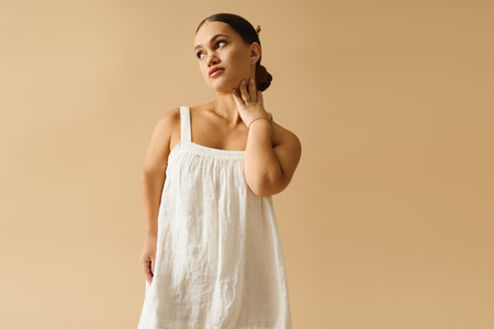 A young woman with short stature poses elegantly in a stylish dress, embracing diversity.の写真素材