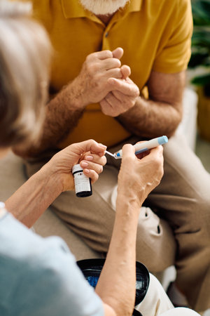A devoted wife helps her husband manage diabetes while they enjoy their time together at home.の写真素材