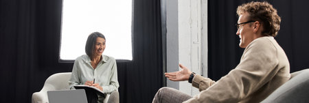A journalist conducts an insightful interview with a specialist in a modern studio, highlighting their expertise.の写真素材