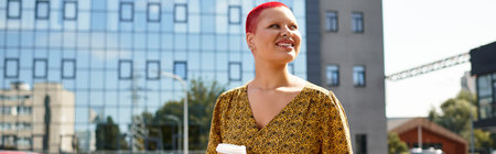 Bright sunlight highlights a bald woman, smiling and savoring her coffee in the city.の写真素材
