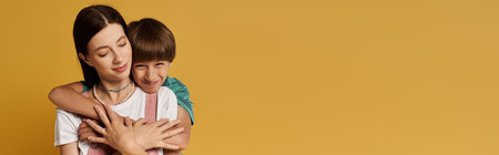 A young mother and her son share a joyful embrace in a bright studio.の写真素材