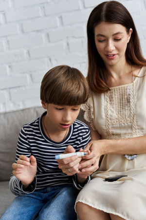 In a modern living room, a young mother lovingly instructs her son about diabetes management.の写真素材