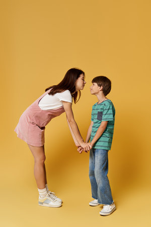 A loving interaction unfolds as a mother and her young son hold hands and connect warmly.の写真素材