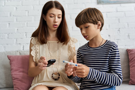 In a cozy living room, a young mother explains diabetes management to her son.の写真素材