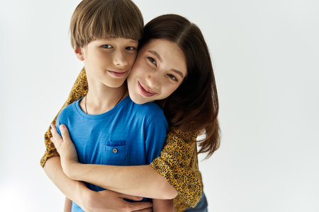 A young mother and her son share a warm embrace, showcasing their bond in a stylish studio.の写真素材