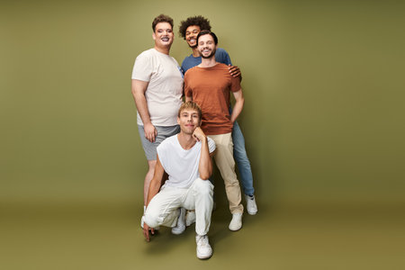 Four individuals celebrate diversity and pride with smiles in a vibrant setting.の写真素材