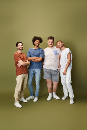 Four friends proudly showcase their bond and individuality against a solid backdrop.の写真素材