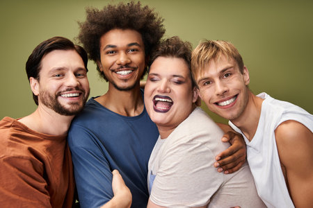 Friends express their pride and joy, embracing one another in a lively atmosphere.の写真素材