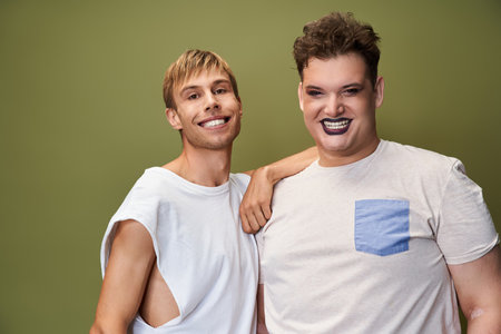 Two friends share joy and pride, smiling brightly in a moment of togetherness.の写真素材