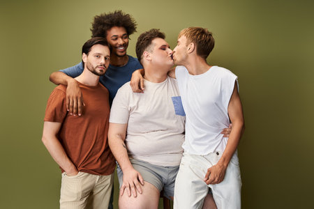 A group of four friends joyfully embraces their bonds and shared love in a colorful backdrop.の写真素材