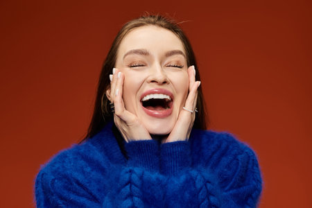 Woman with a vibrant smile engages joyfully, showcasing her stylish outfit and positive energy.の写真素材