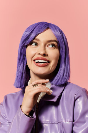 A confident woman with purple hair and a stylish outfit smiles joyfully.の写真素材