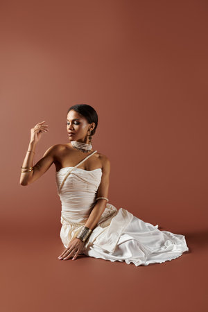 An elegant African American woman in a stunning white dress captivates with her pearl accessories...