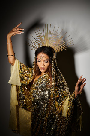 In a captivating studio, a stunning figure adorned in gold captivates with her graceful dance and...