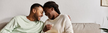 A happy couple shares laughter and love while enjoying quality time together at home.の写真素材