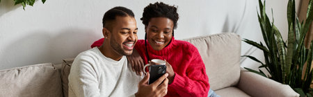 Happy couple snuggles together in their living room, enjoying quality time and warmth.の写真素材