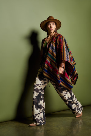 Brunette dazzles in a vibrant outfit blending traditional and modern styles.