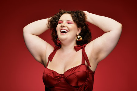 A stylish woman laughs while posing, showcasing her trendy, vibrant attire.の写真素材